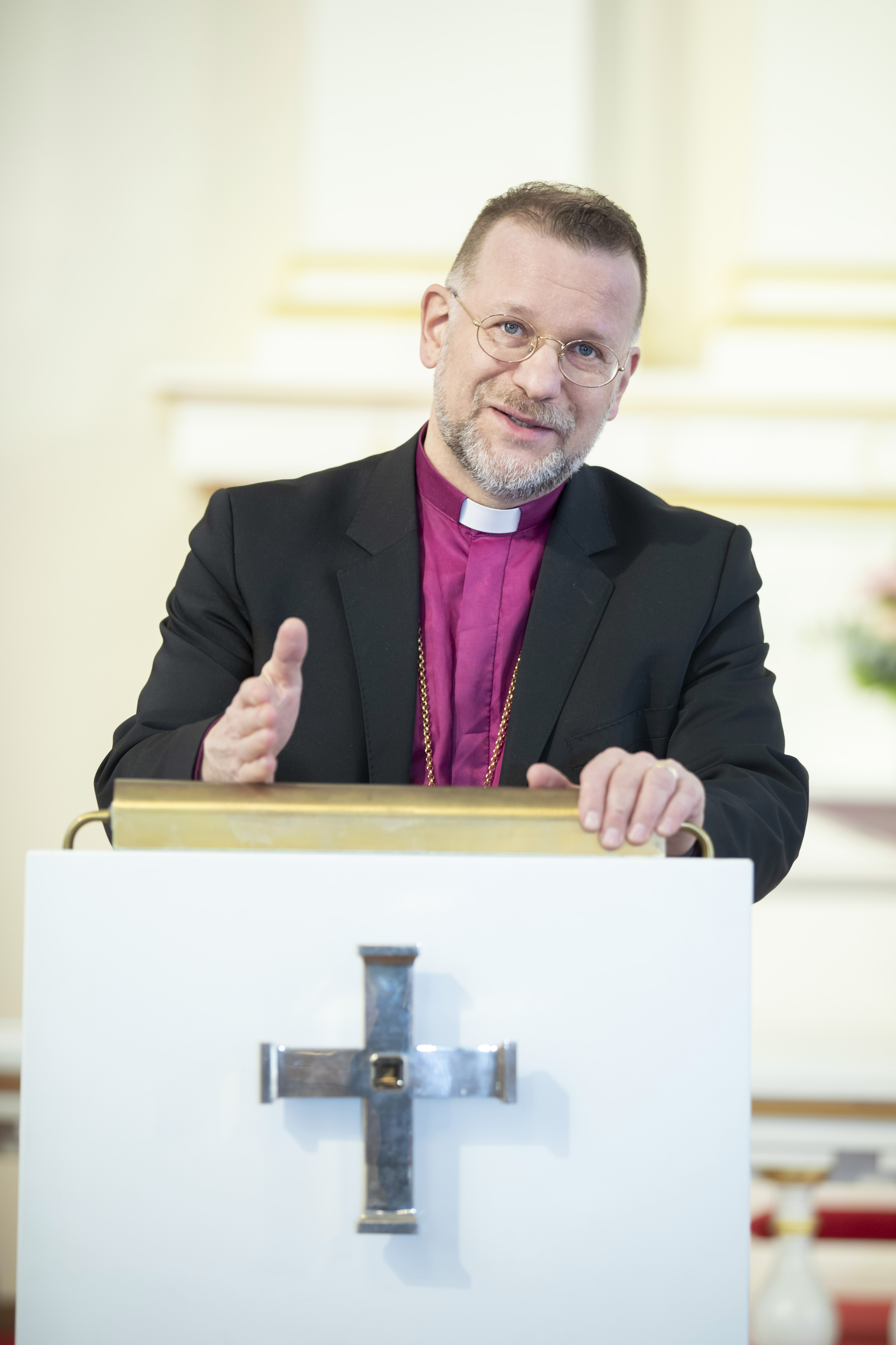 Piispa Jari Jolkkonen puhujanpöntössä ja katsoo suoraan eteenpäin.