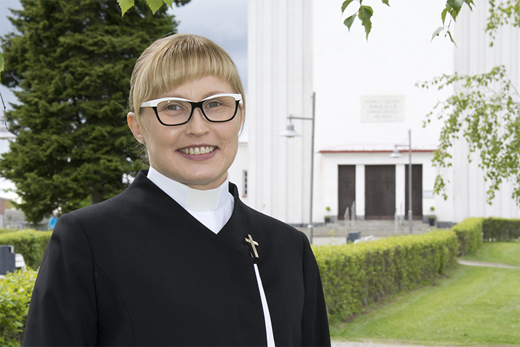 Iisalmen seurakunnan kirkkoherra Sanna Komulainen Pyhän Ristin kirkon edustalla.